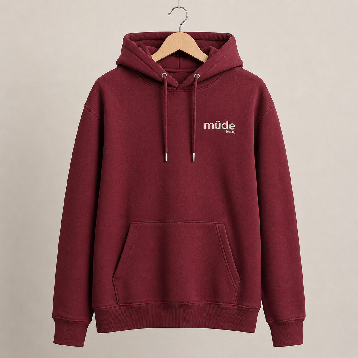 Bordeauxroter Bio Hoodie müde von JoisPulse mit gesticktem Statement, flach liegend