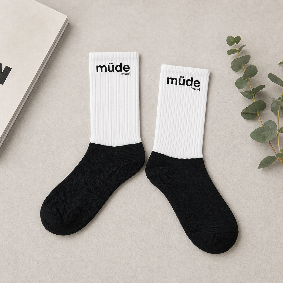 Schwarz-weiße Statement Socken müde von JoisPulse, flach liegend fotografiert